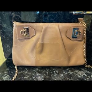 Salvatore Ferragamo soft leather clutch with adjustable gold chain.